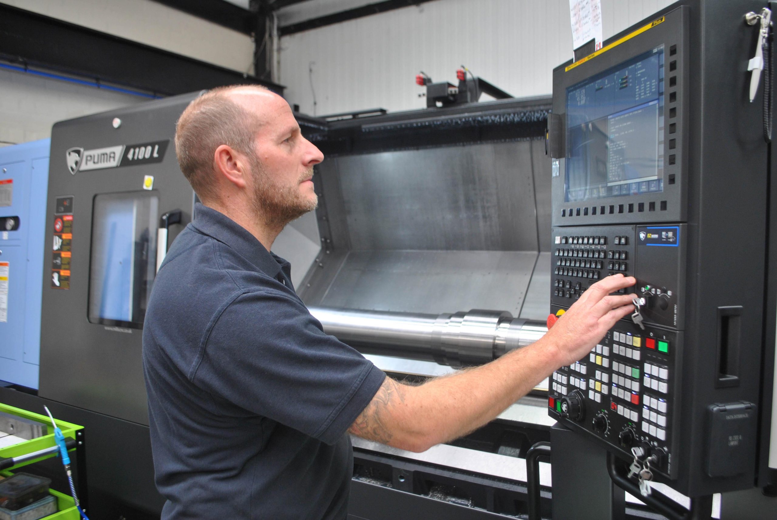 Operator using a Puma 4100LB Horizontal Single Turret Lathe at Wordsley Engineering